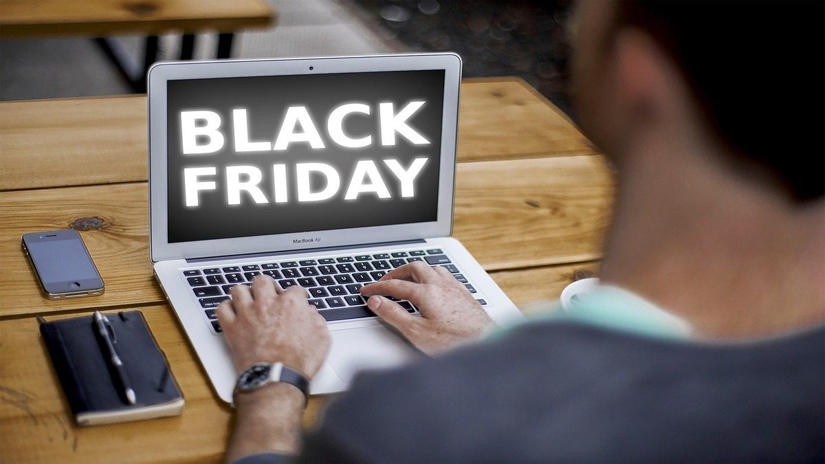 Imagem de homem usando notebook e pesquisando preços na Black Friday